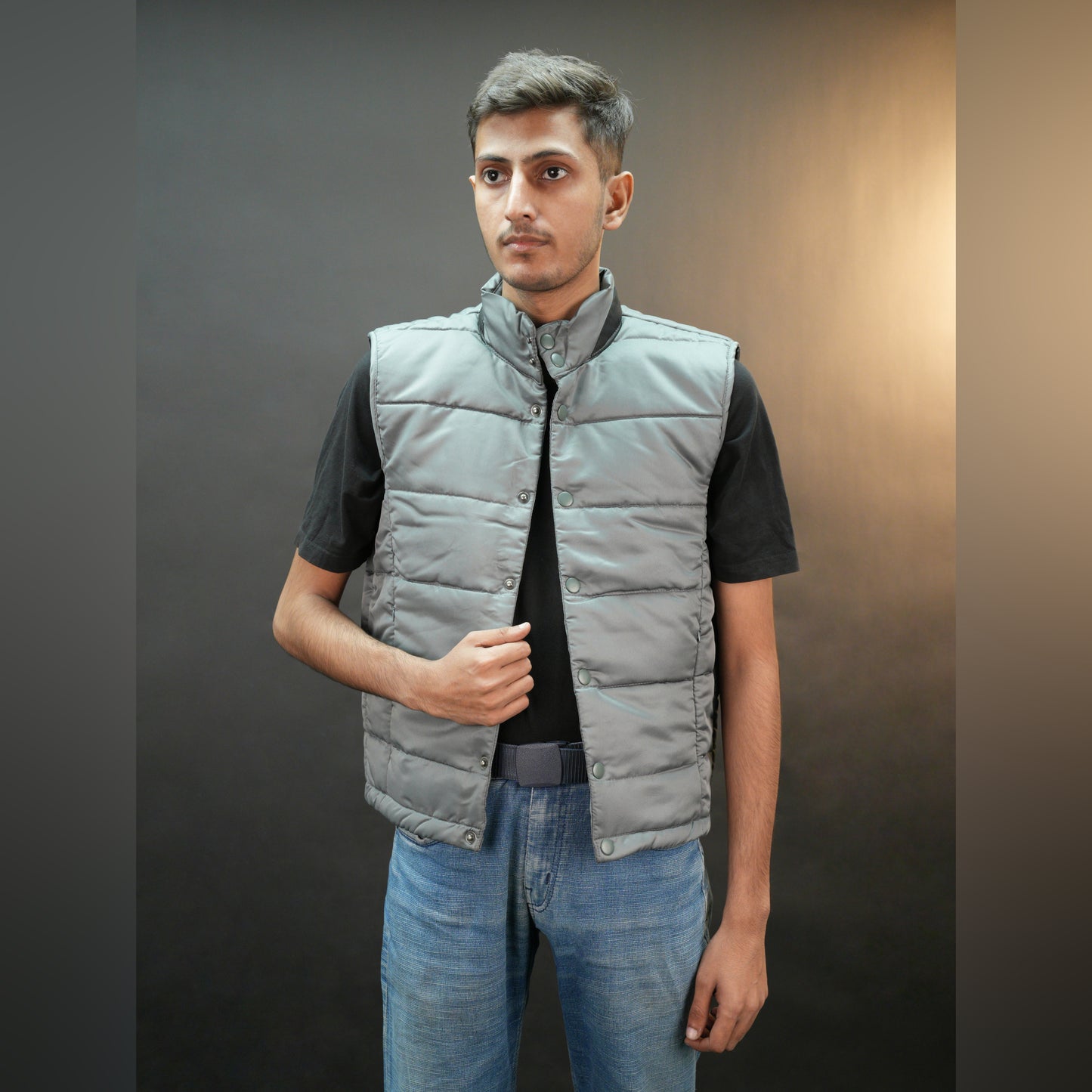 Grey jacket with a button closure, snap-button side pockets, and a single inner pocket for easy and secure storage