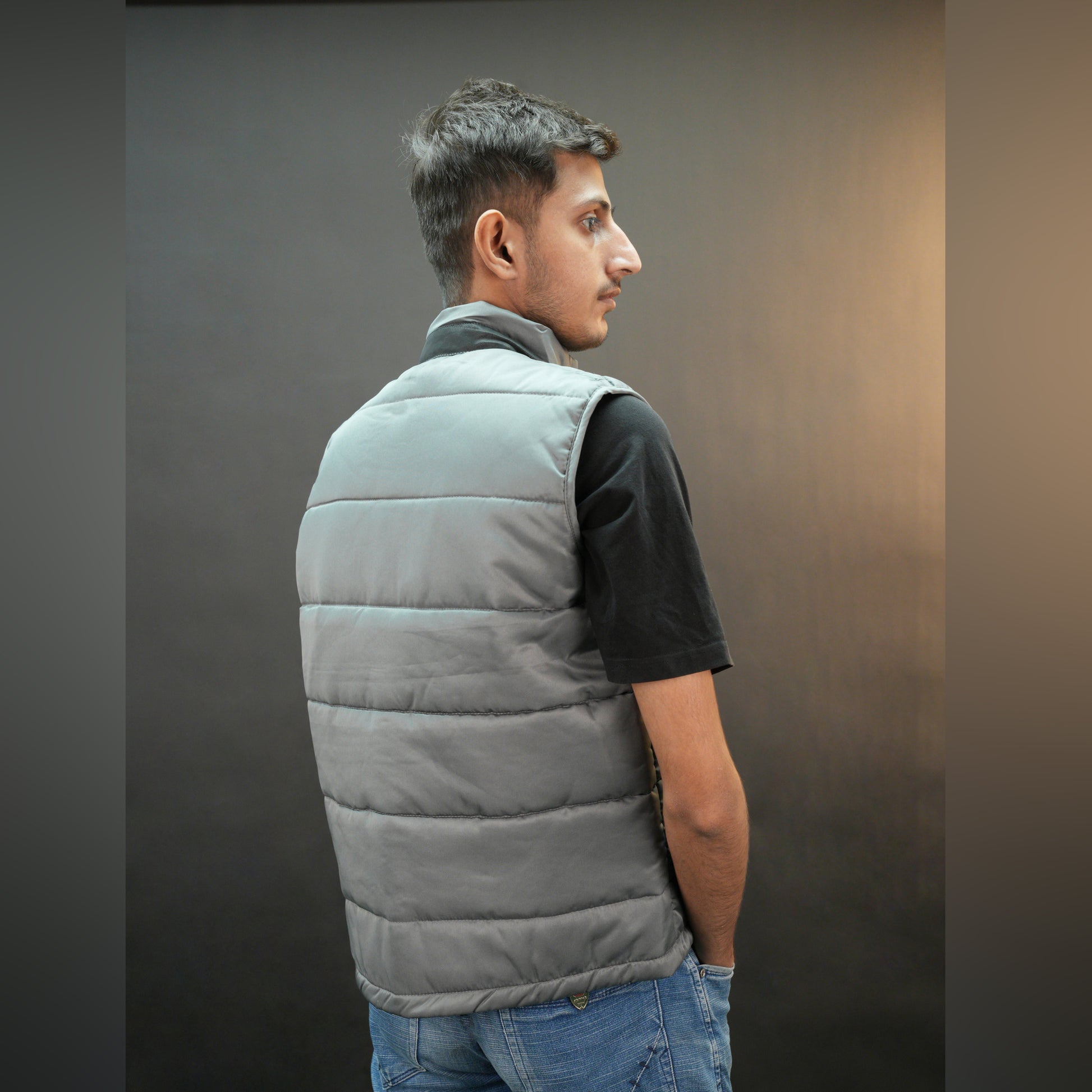 Grey jacket with a button closure, snap-button side pockets, and a single inner pocket for easy and secure storage