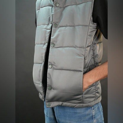 Grey jacket with a button closure, snap-button side pockets, and a single inner pocket for easy and secure storage