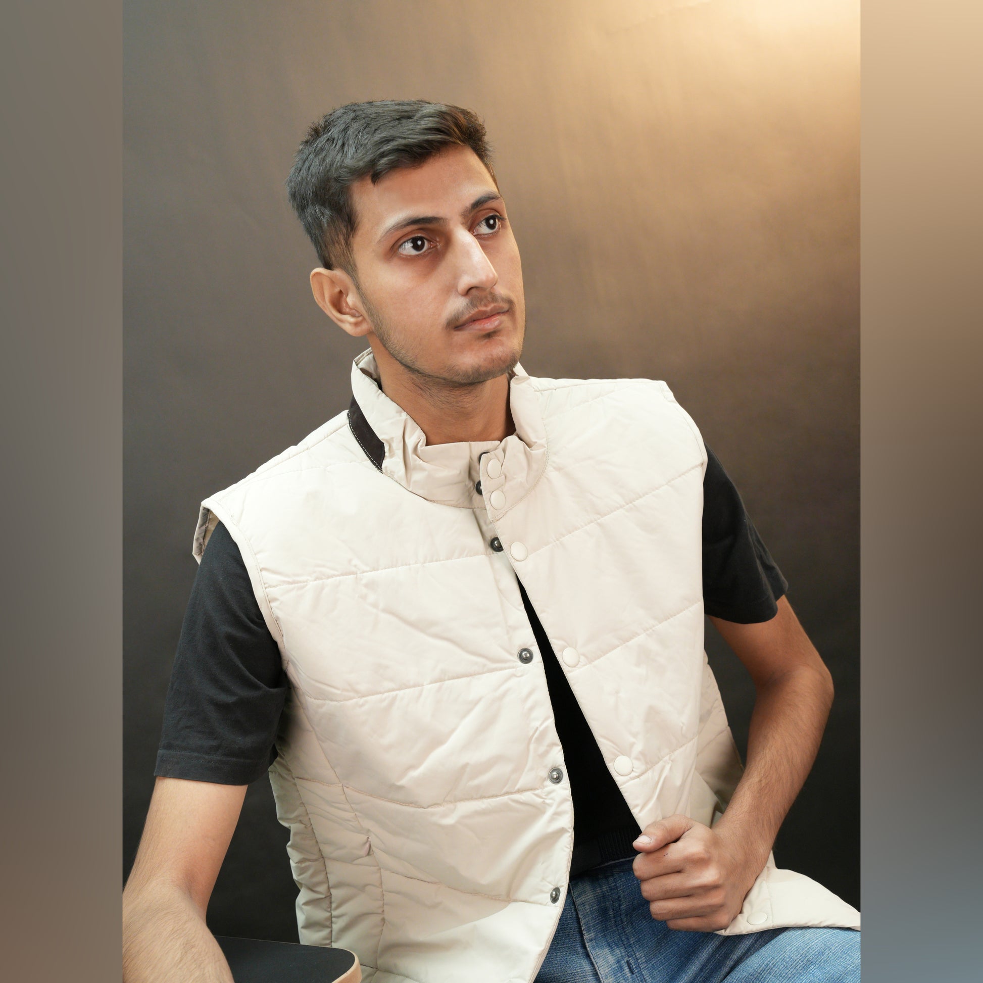 Beige jacket featuring a button closure, two snap-button side pockets, and one inner pocket for convenient, secure storage