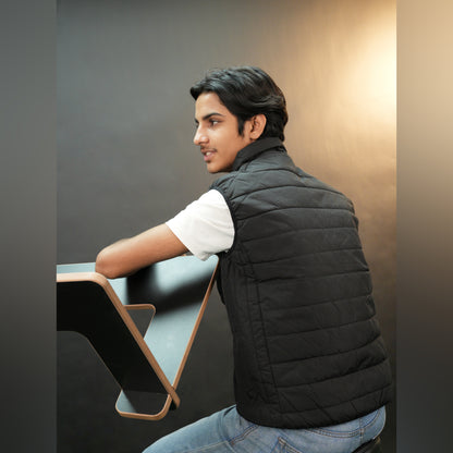 Black garment featuring a front zip closure, two snap-button side pockets, and two inside pockets for secure, convenient storage