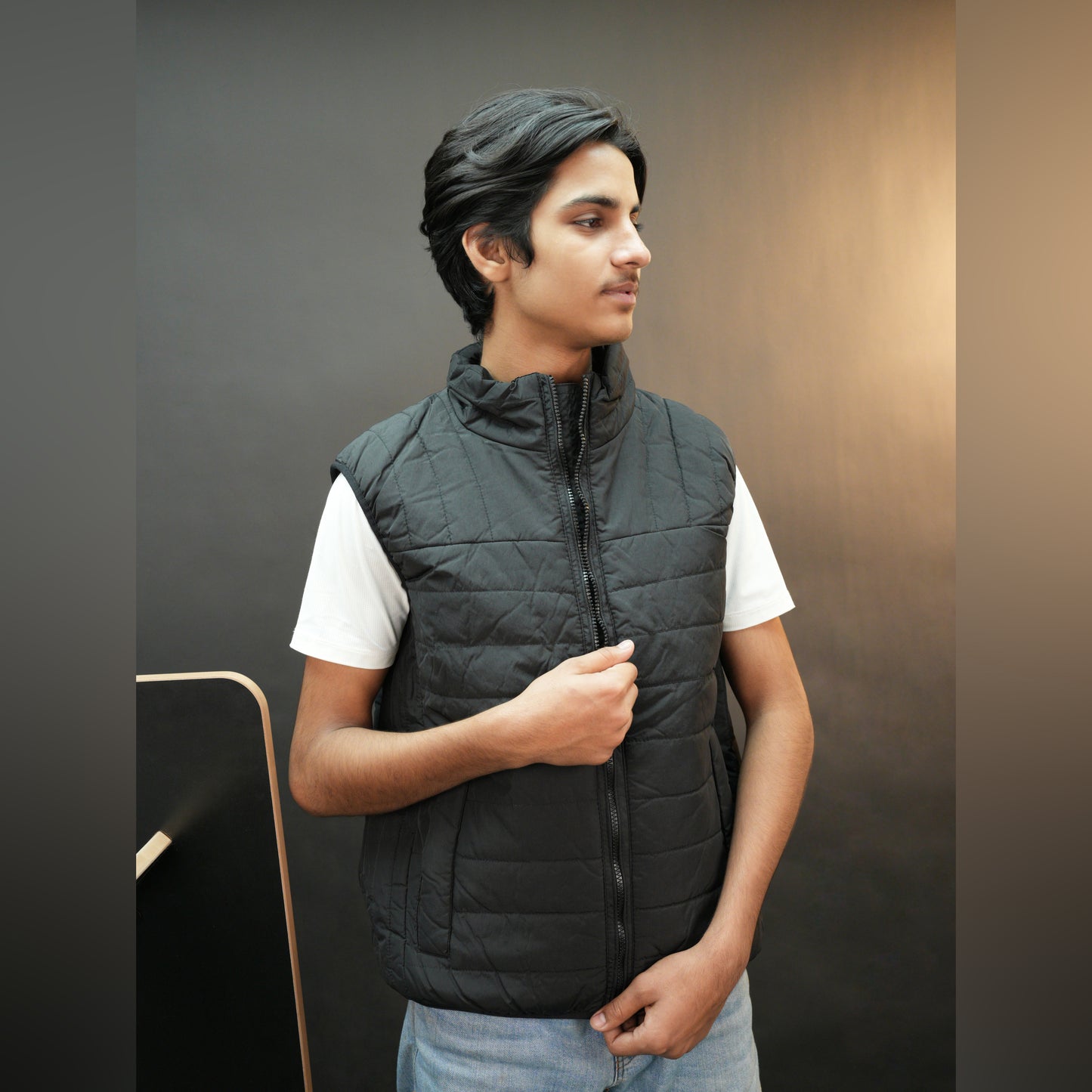 Black garment featuring a front zip closure, two snap-button side pockets, and two inside pockets for secure, convenient storage