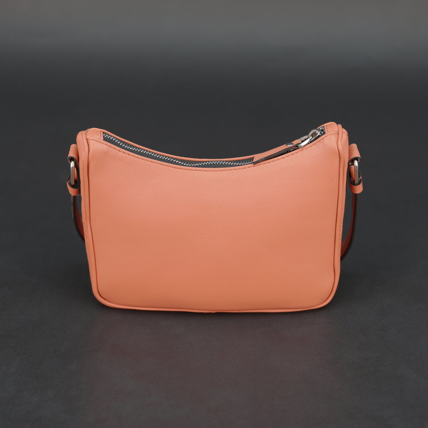 Coral sheep leather bag with zip closure and pockets.