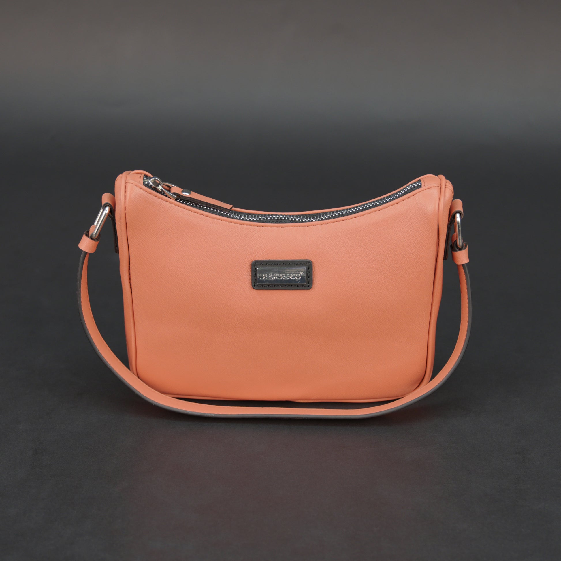 Coral sheep leather bag with zip closure and pockets.