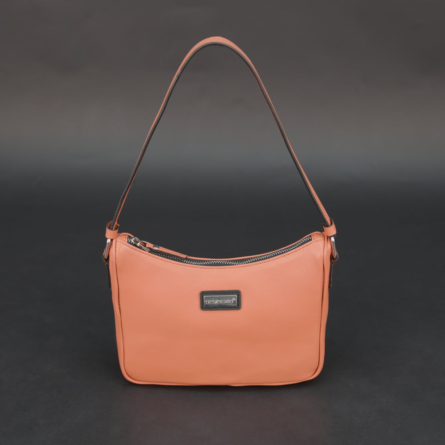 Coral sheep leather bag with zip closure and pockets.