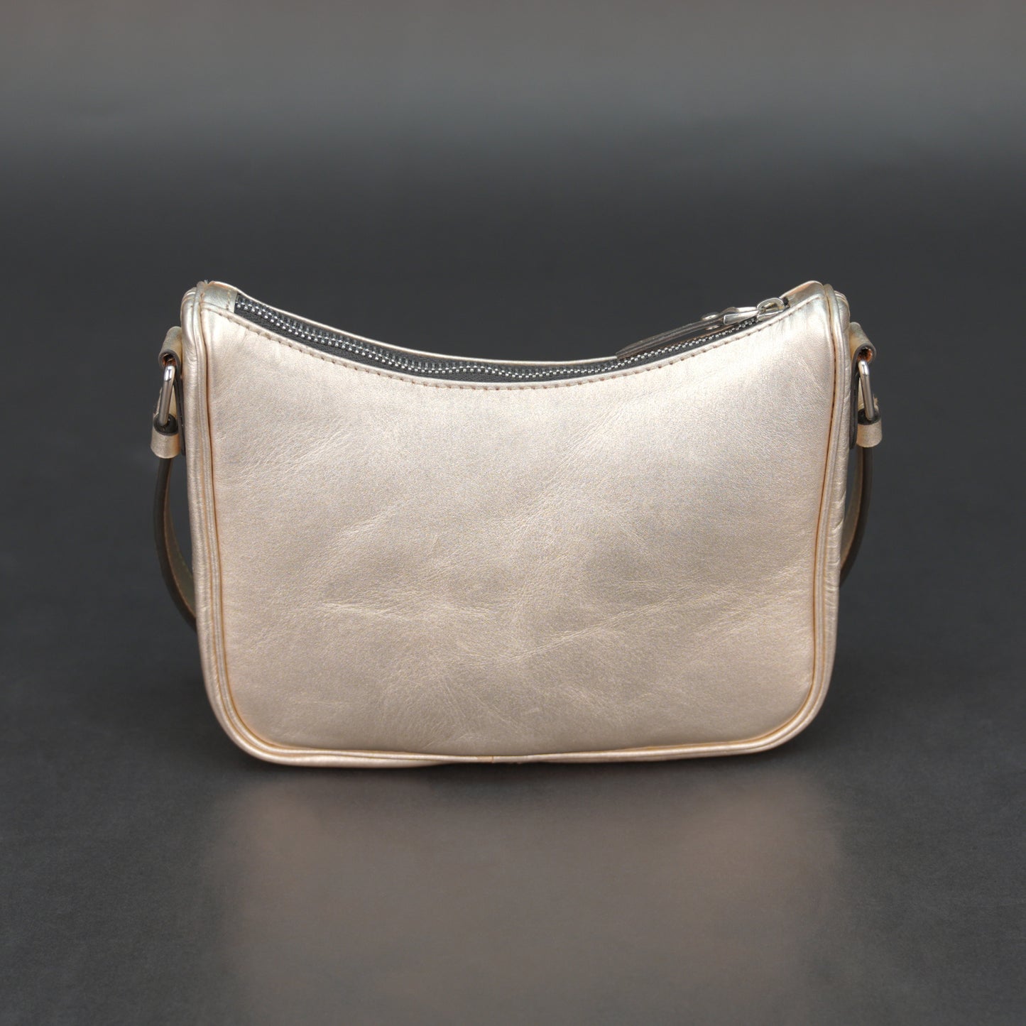 Metallic premium cow leather bag with zip closure, main compartment, and inner pocket for daily use.