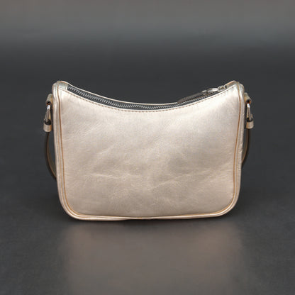 Metallic premium cow leather bag with zip closure, main compartment, and inner pocket for daily use.