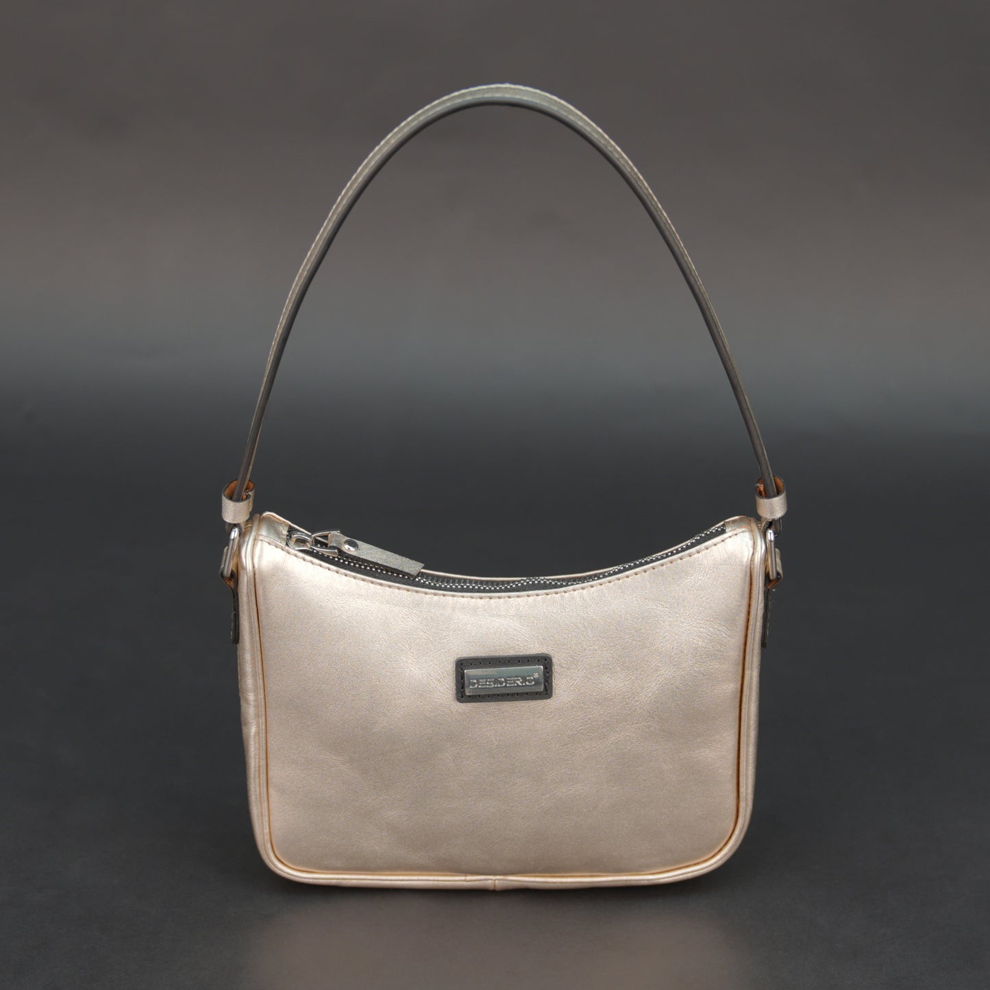 Metallic premium cow leather bag with zip closure, main compartment, and inner pocket for daily use.