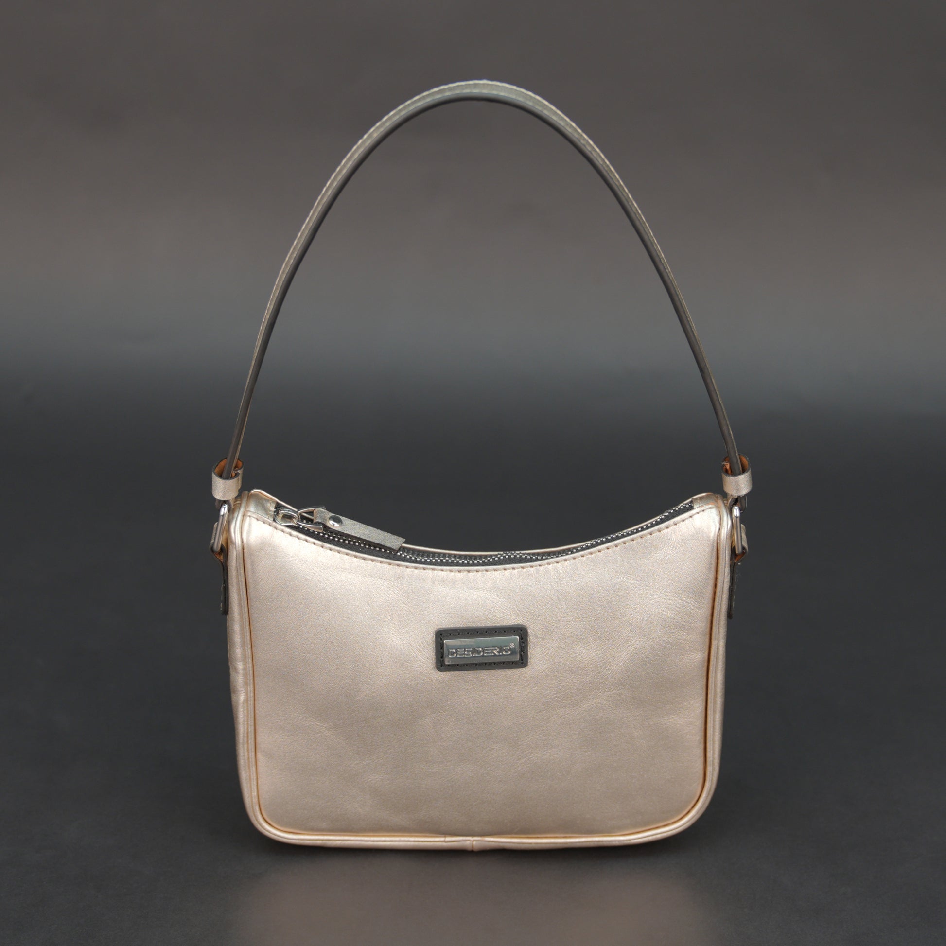 Metallic premium cow leather bag with zip closure, main compartment, and inner pocket for daily use.
