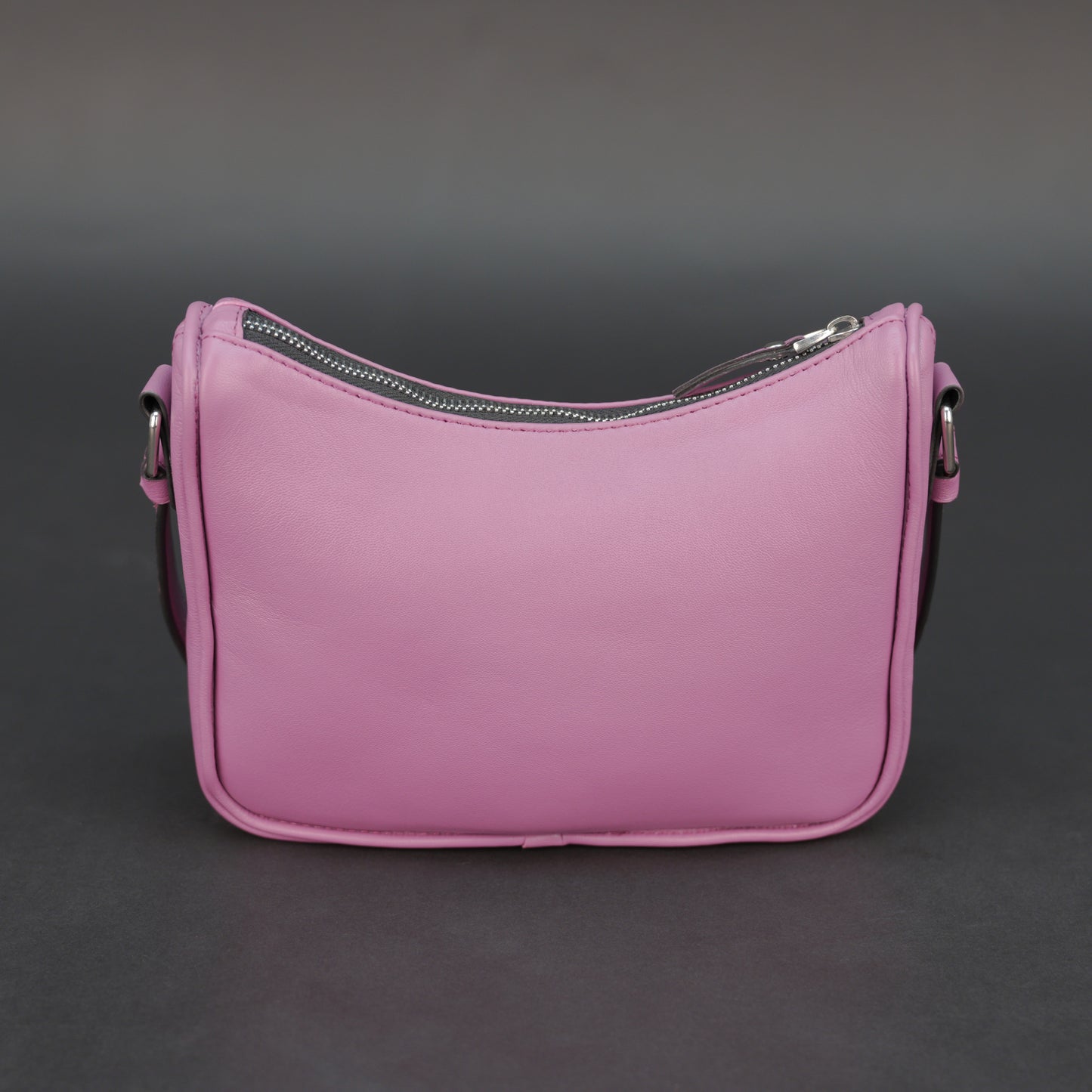 Pink sheep leather bag with zip closure and inner pocket.