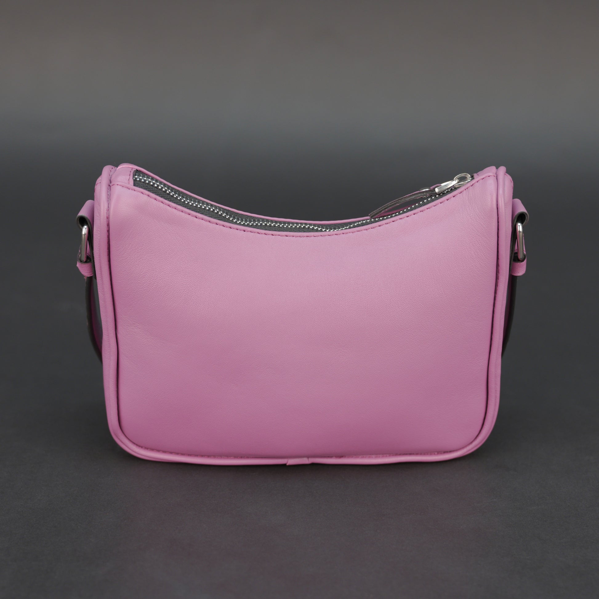 Pink sheep leather bag with zip closure and inner pocket.