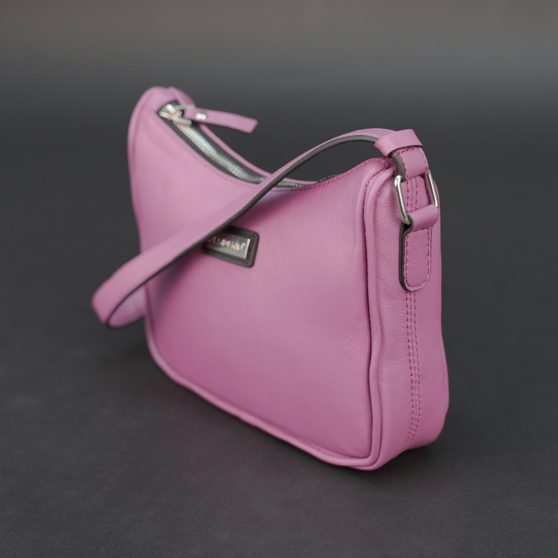 Pink sheep leather bag with zip closure and inner pocket.