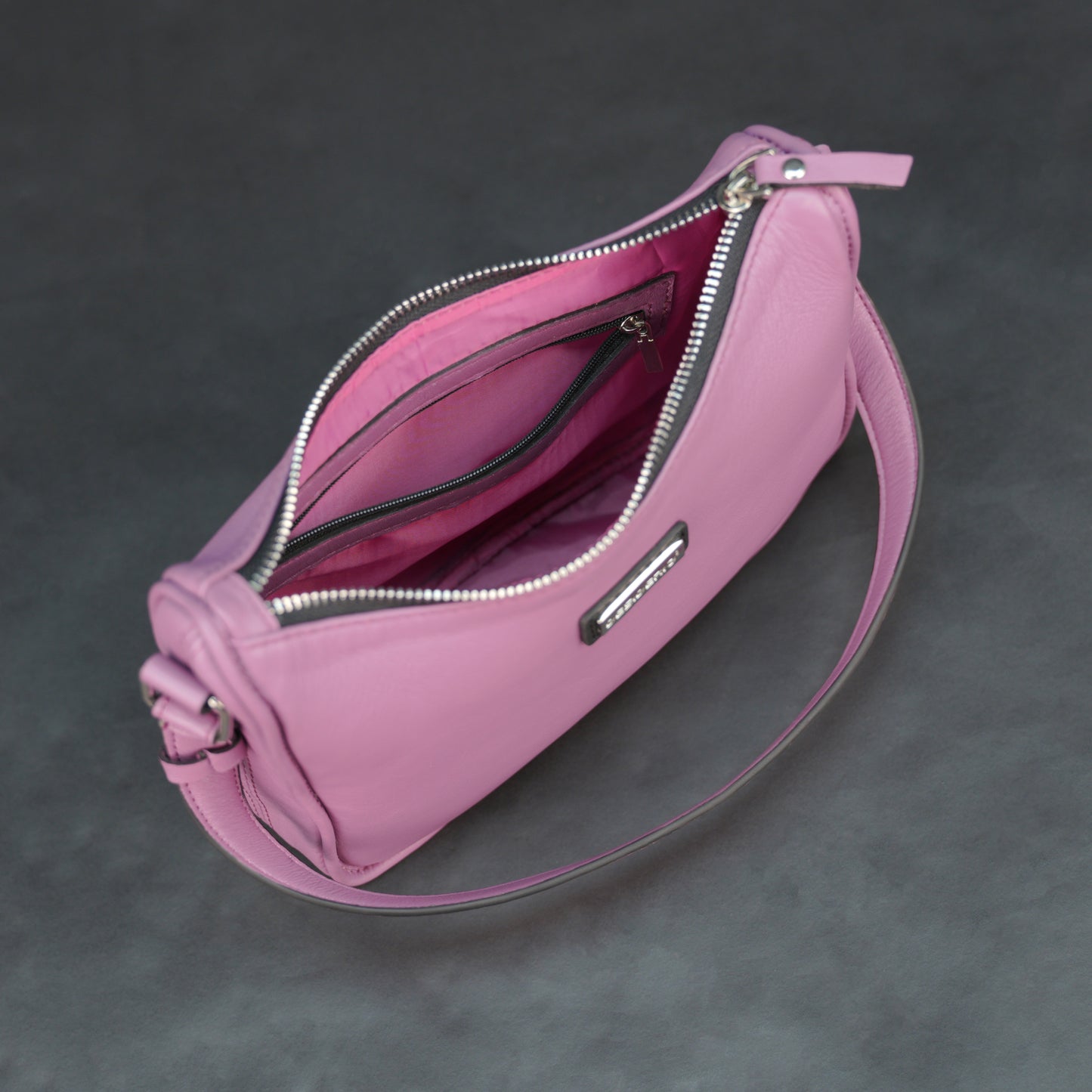 Pink sheep leather bag with zip closure and inner pocket.