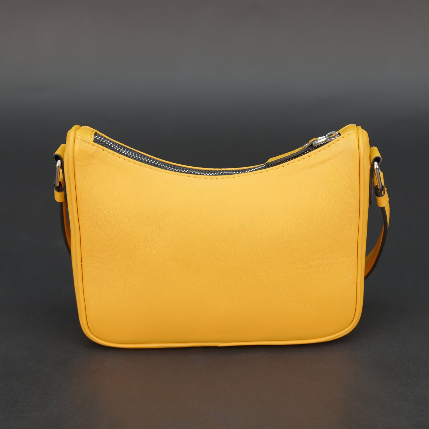 Yellow sheep leather bag with zip closure and inner pocket.