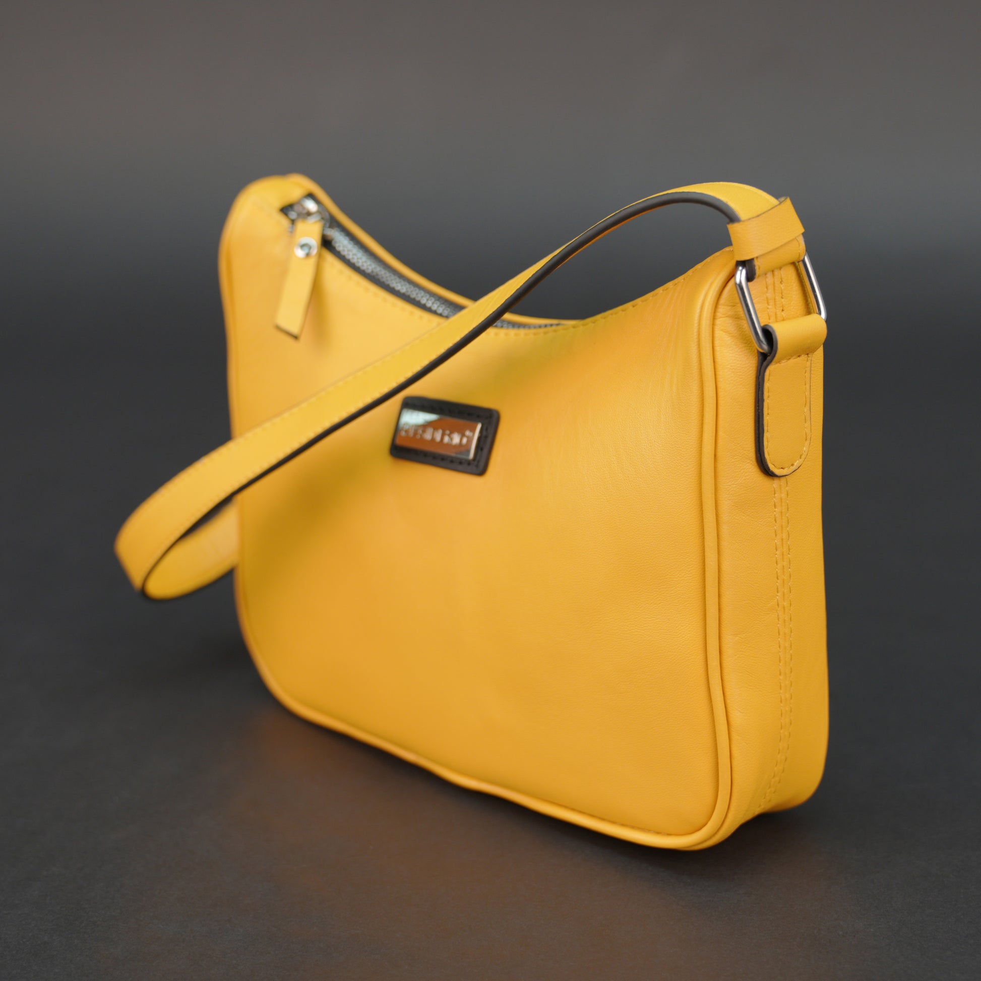 Yellow sheep leather bag with zip closure and inner pocket.