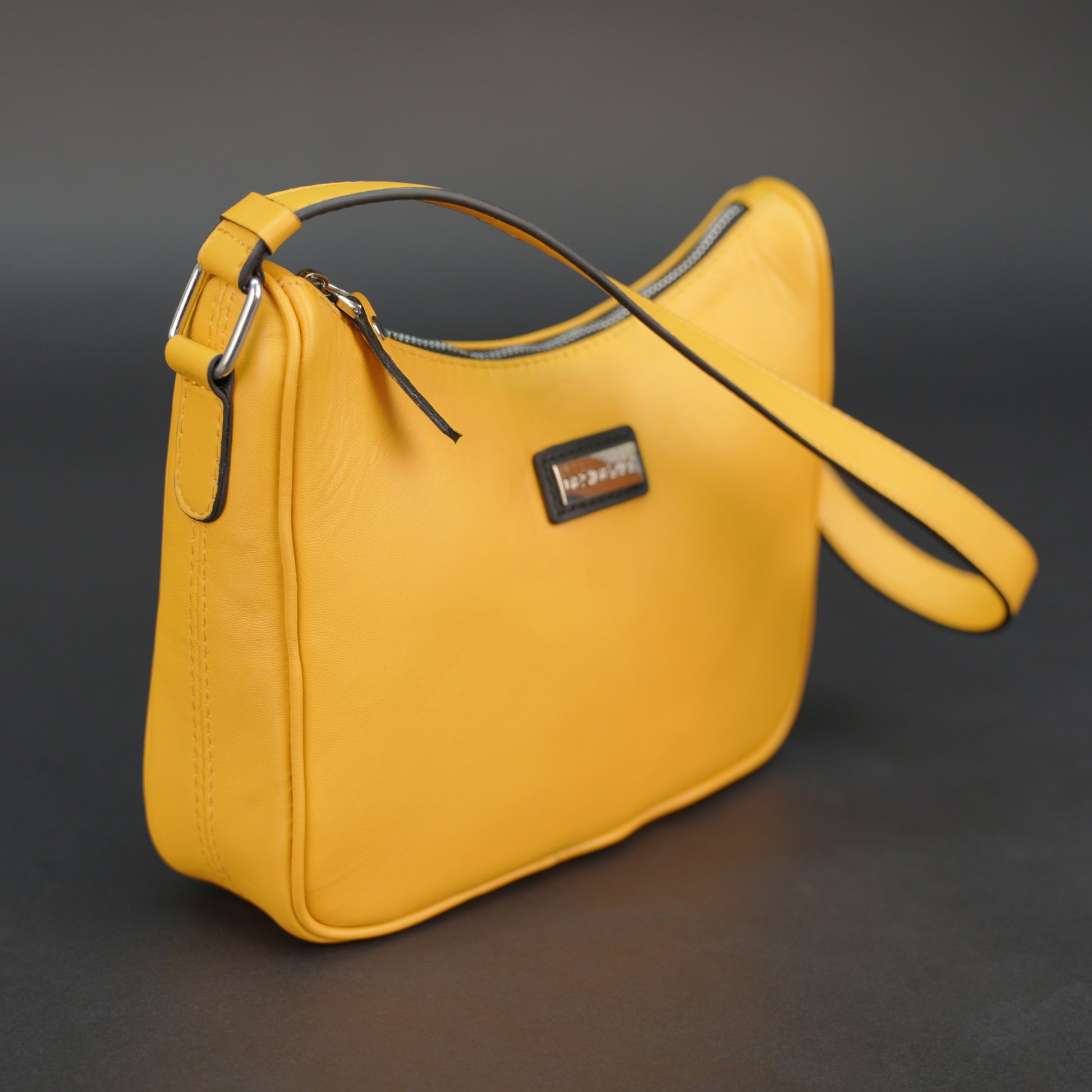 Yellow sheep leather bag with zip closure and inner pocket.