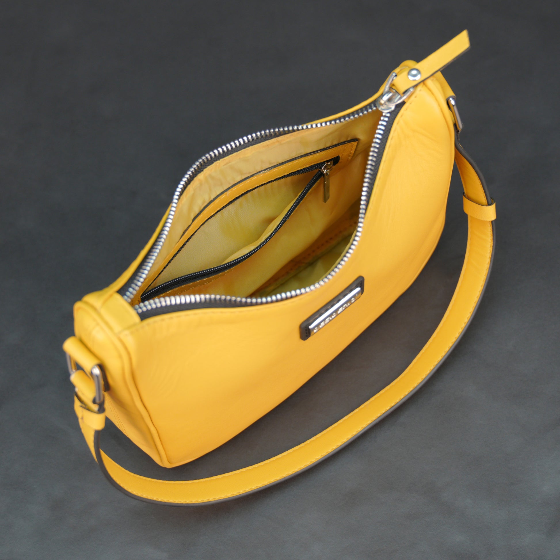 Yellow sheep leather bag with zip closure and inner pocket.