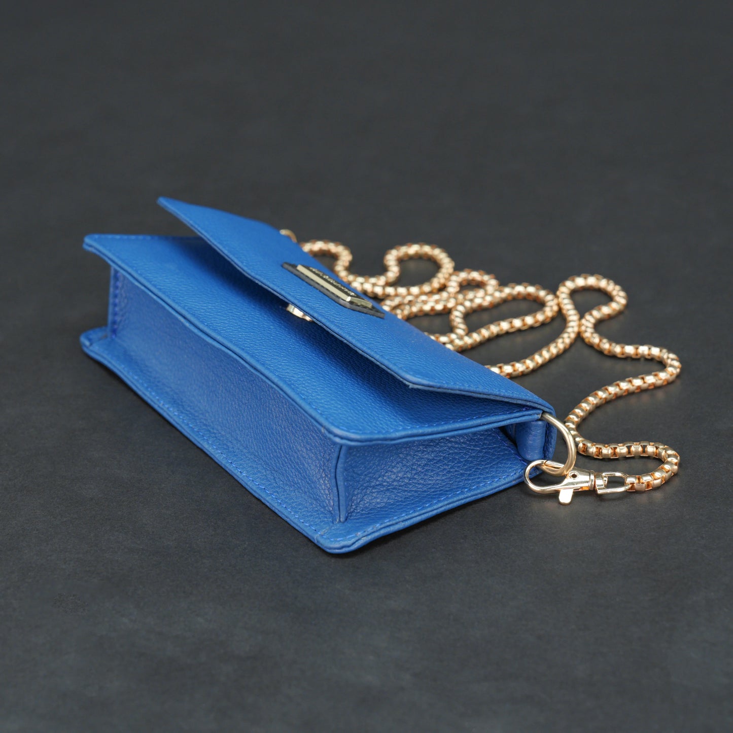 Blue cow PDM leather bag with chain strap, main compartment, and inner pocket.