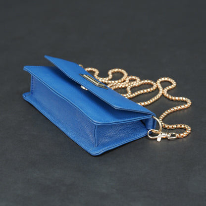 Blue cow PDM leather bag with chain strap, main compartment, and inner pocket.