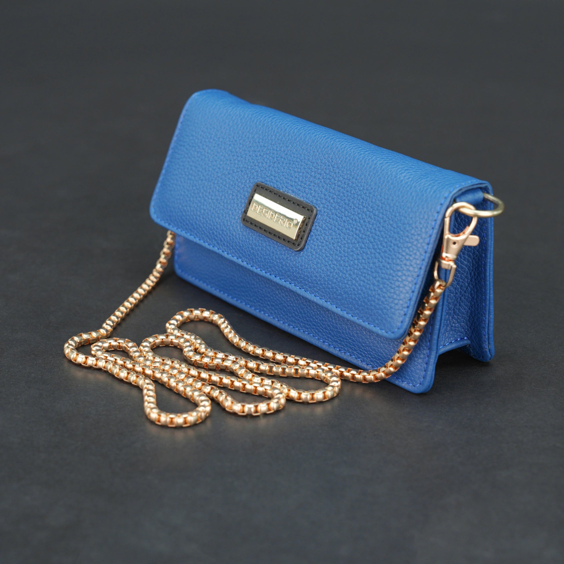 Blue cow PDM leather bag with chain strap, main compartment, and inner pocket.