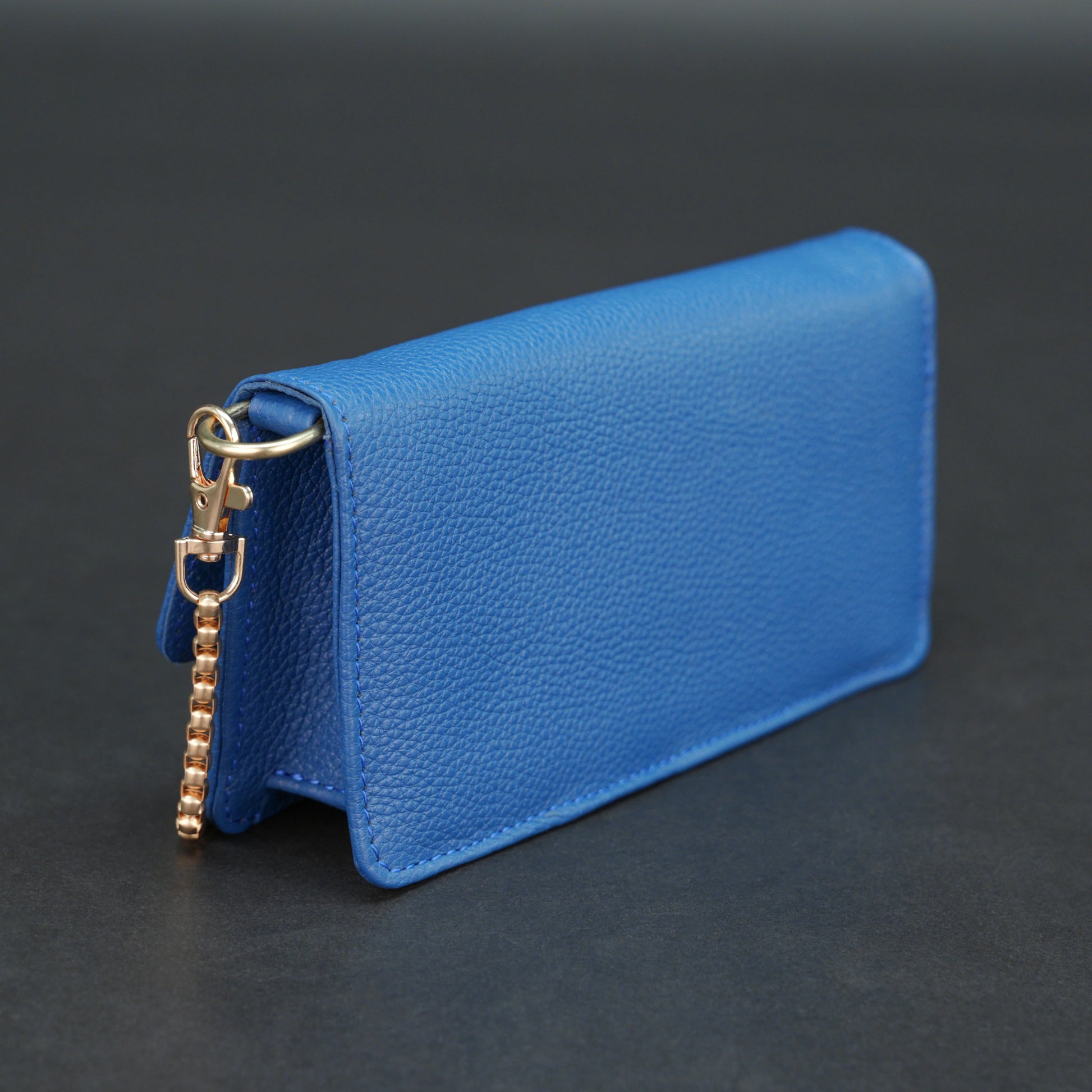 Blue cow PDM leather bag with chain strap, main compartment, and inner pocket.