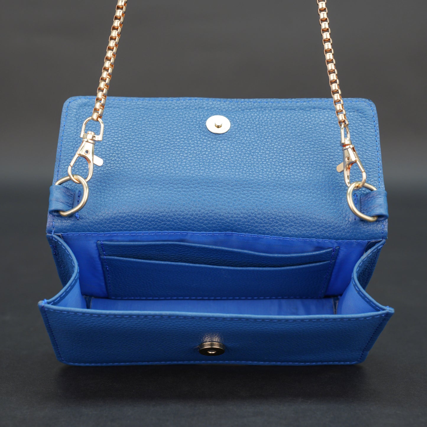 Blue cow PDM leather bag with chain strap, main compartment, and inner pocket.