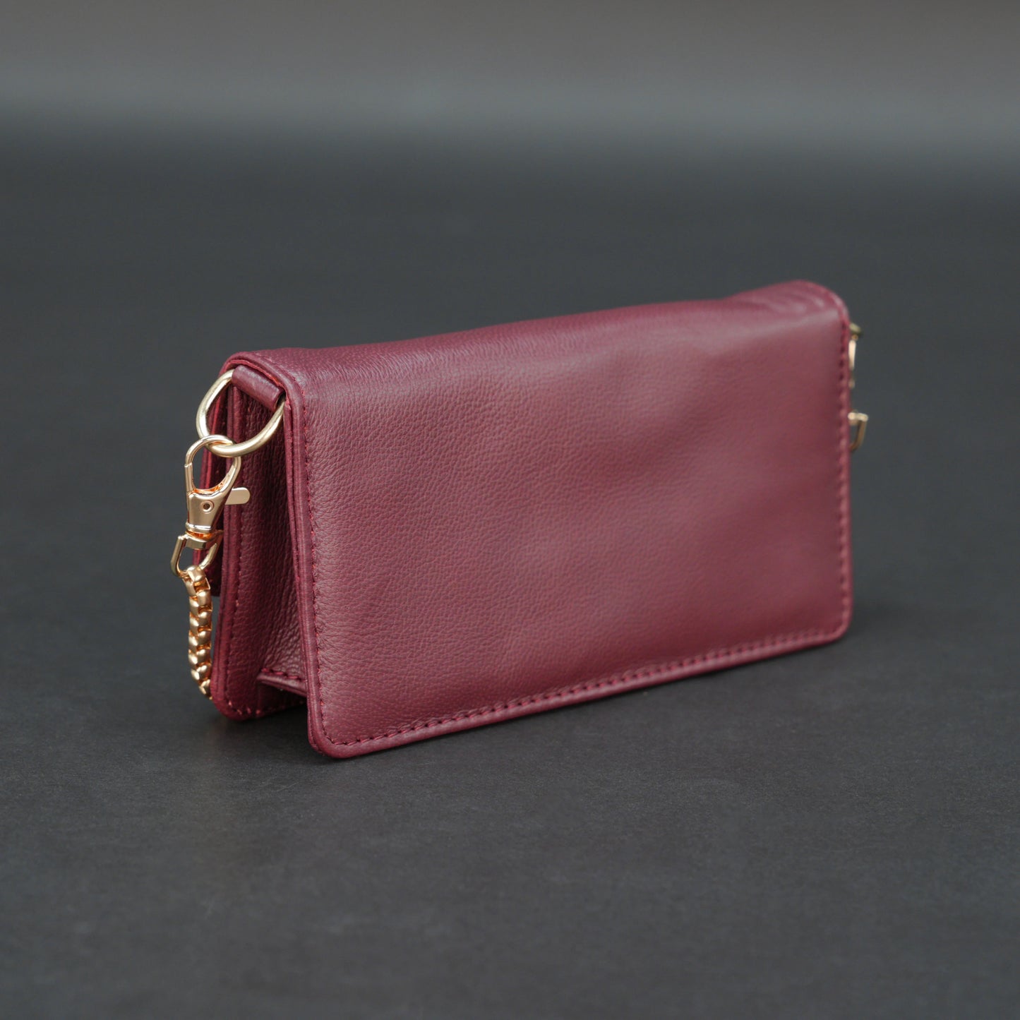 Burgundy goat leather bag with chain strap, main compartment, and inner pocket.