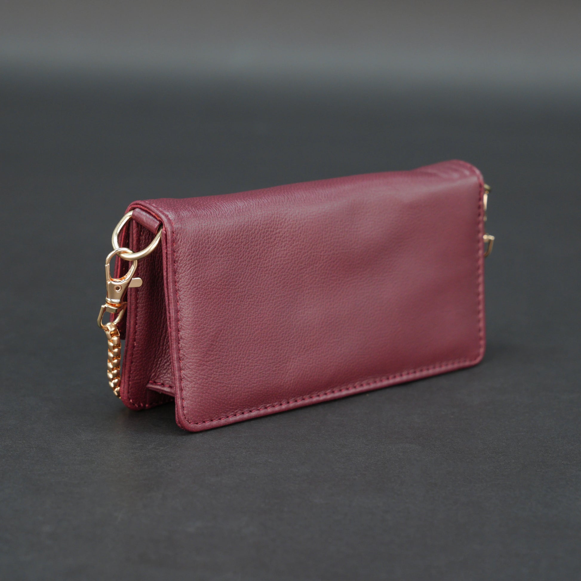 Burgundy goat leather bag with chain strap, main compartment, and inner pocket.