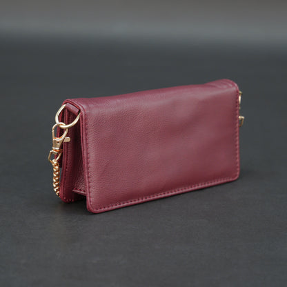 Burgundy goat leather bag with chain strap, main compartment, and inner pocket.