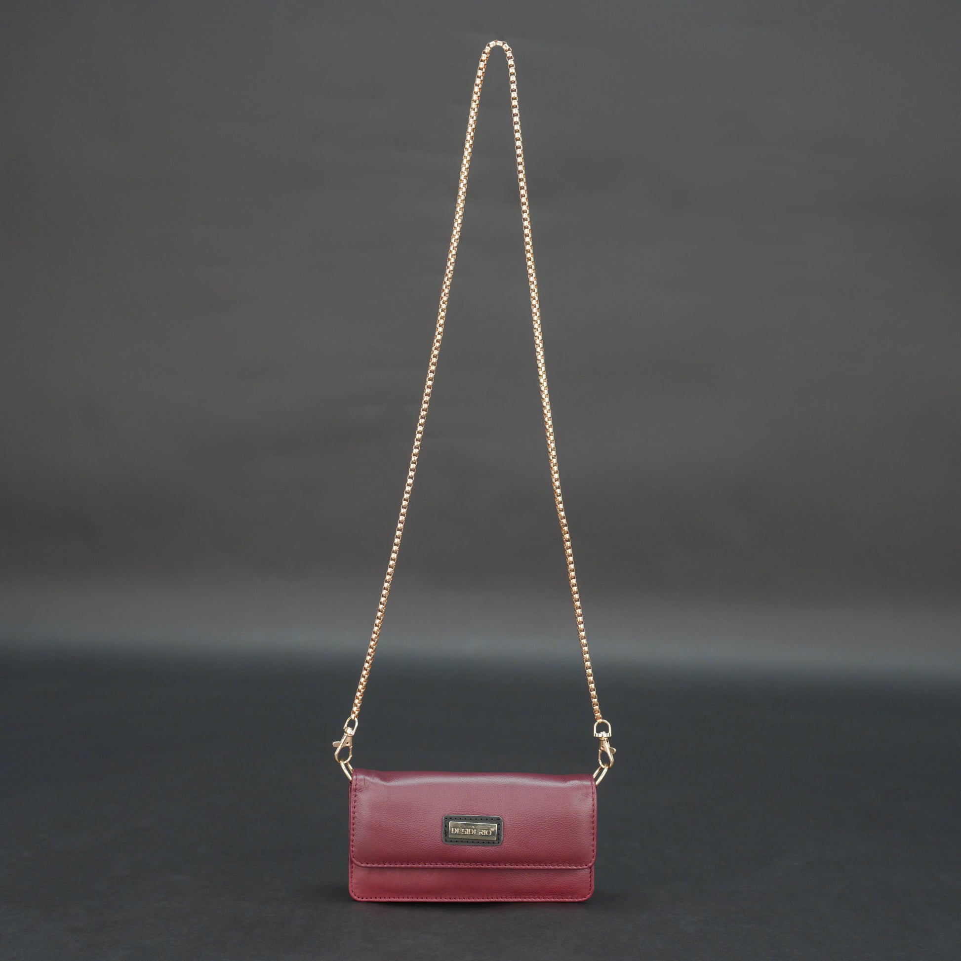 Burgundy goat leather bag with chain strap, main compartment, and inner pocket.