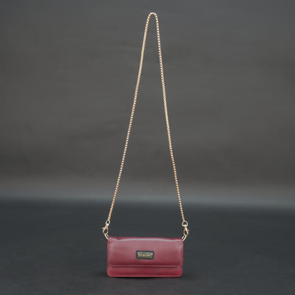 Burgundy goat leather bag with chain strap, main compartment, and inner pocket.