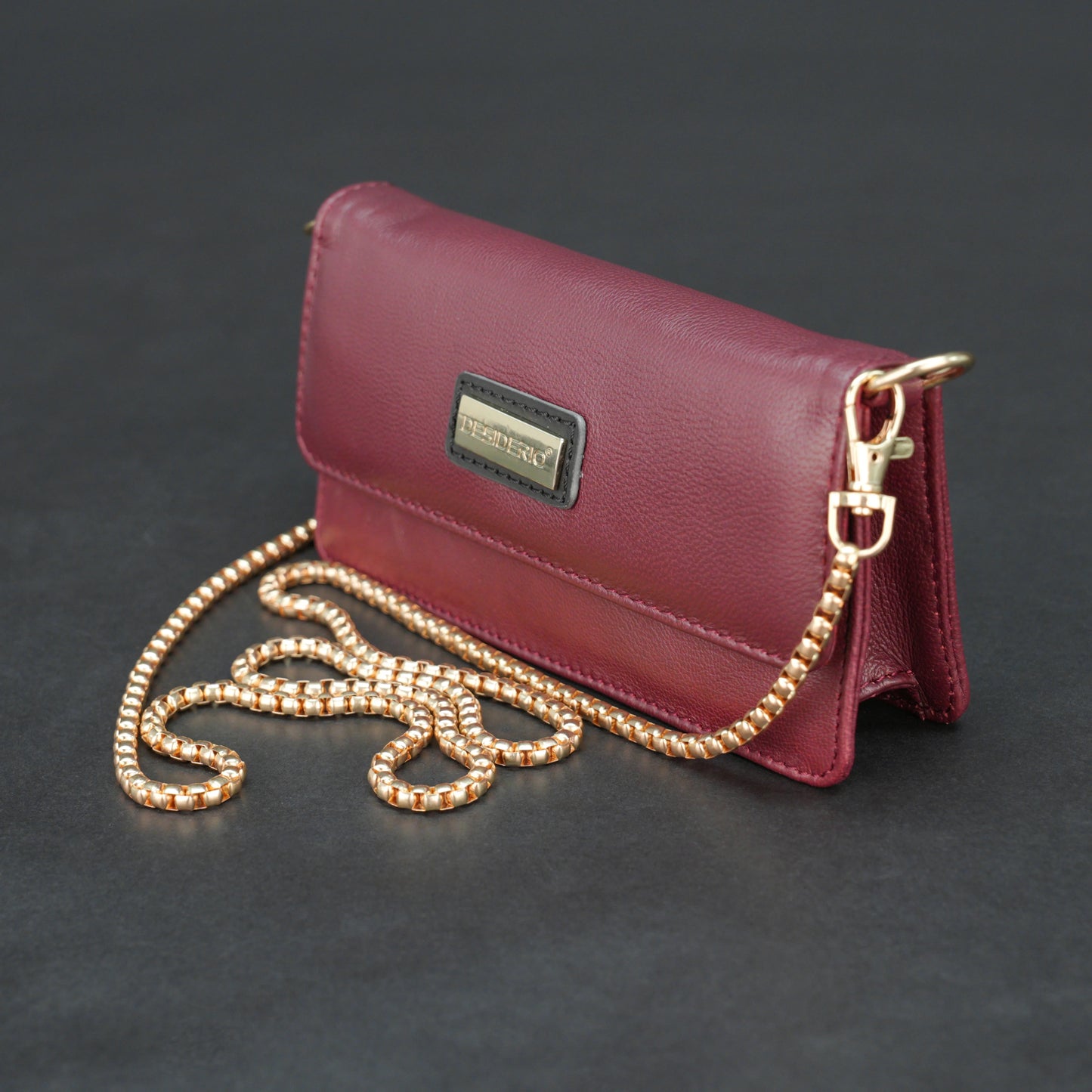 Burgundy goat leather bag with chain strap, main compartment, and inner pocket.