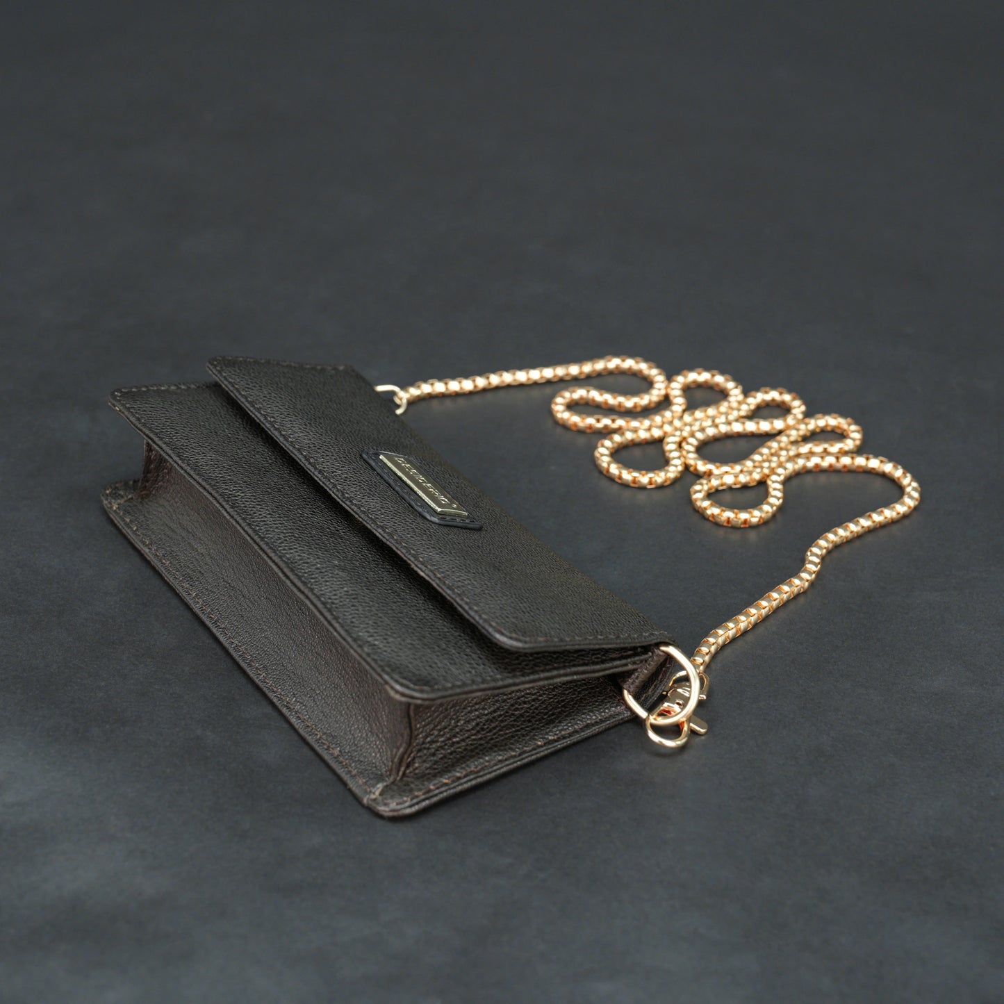 Dark brown goat leather bag with chain strap, main compartment, and inner pocket.