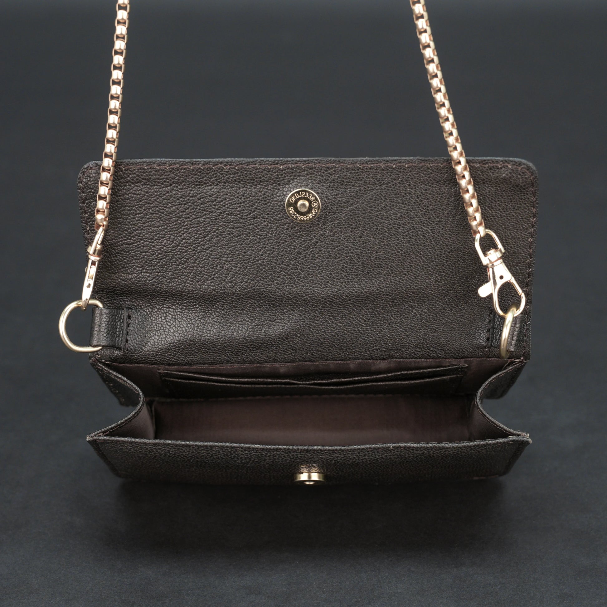 Dark brown goat leather bag with chain strap, main compartment, and inner pocket.
