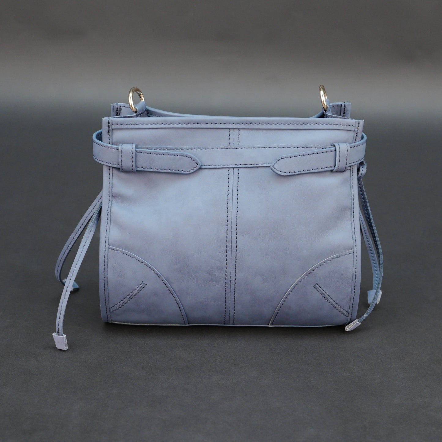 Light blue cow leather bag with shoulder strap, main compartment, and inner pockets.