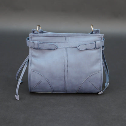 Light blue cow leather bag with shoulder strap, main compartment, and inner pockets.