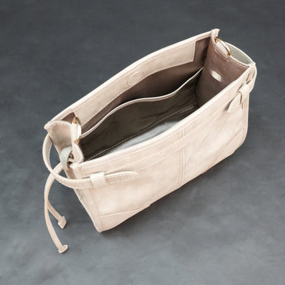 Cream cow Manisota leather bag with shoulder strap and pockets.