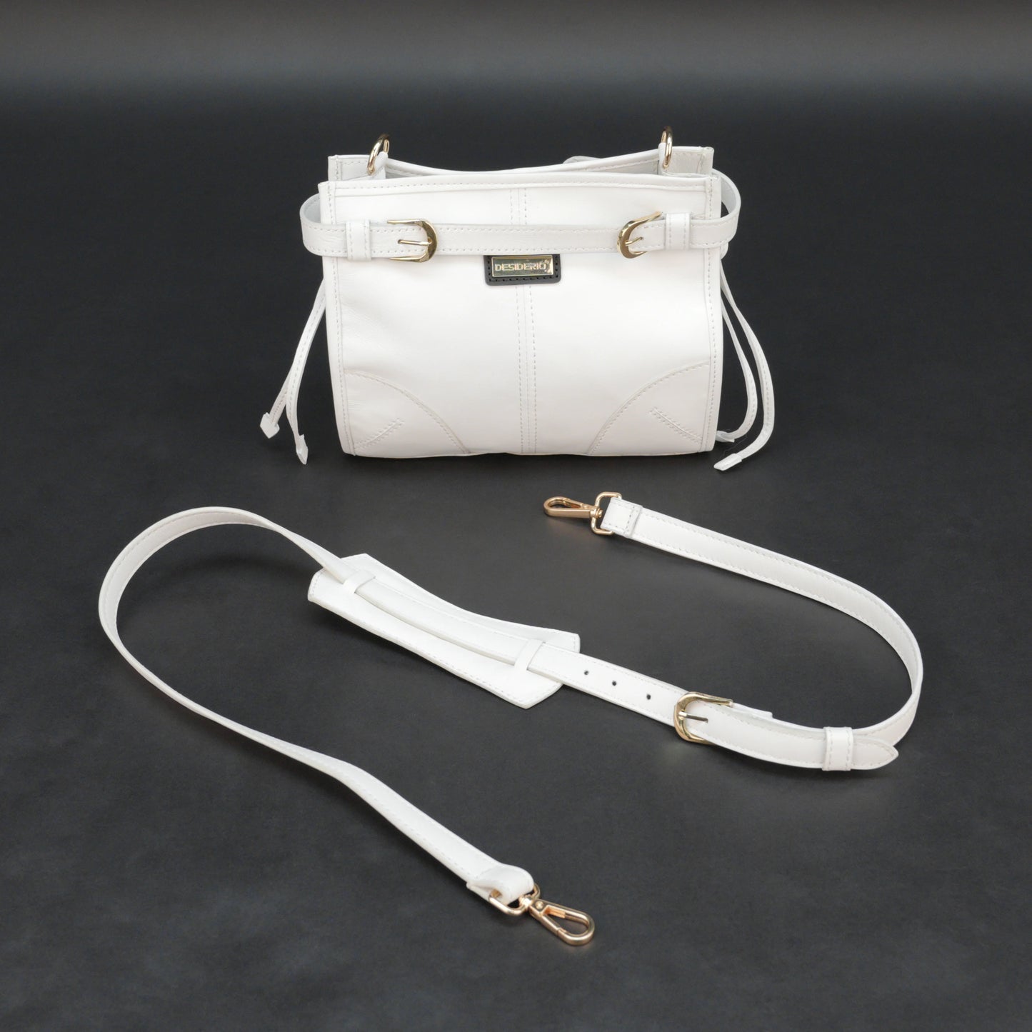 White sheep leather bag with shoulder strap and pockets.