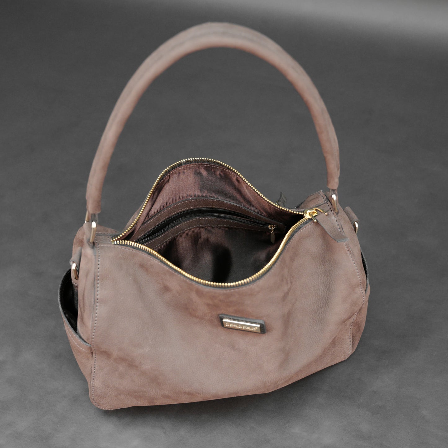 Choco cow Chelsea leather bag with zip compartments and pockets.
