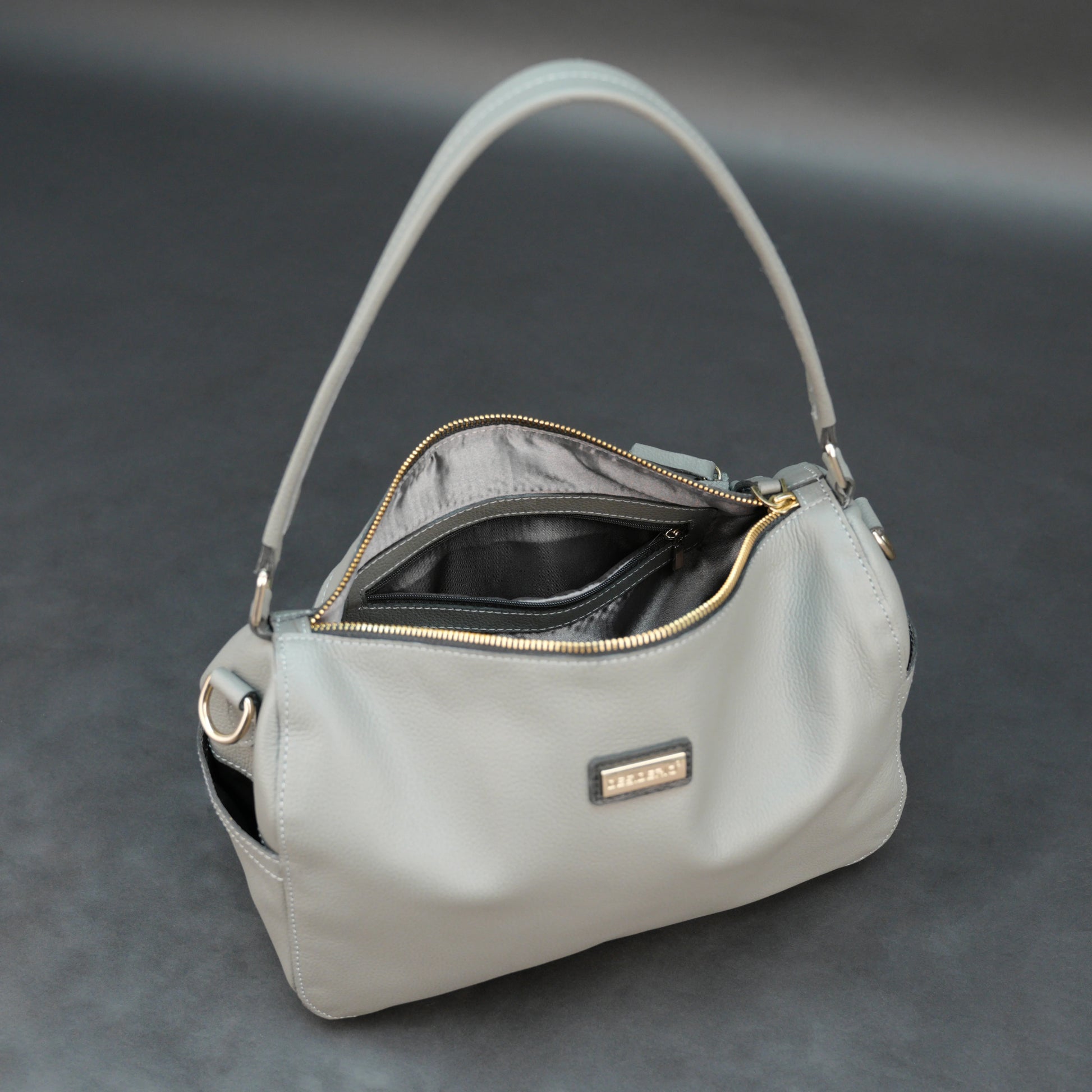 Silver cow Chelsea leather bag with zip closure, multiple pockets, and durable everyday design.