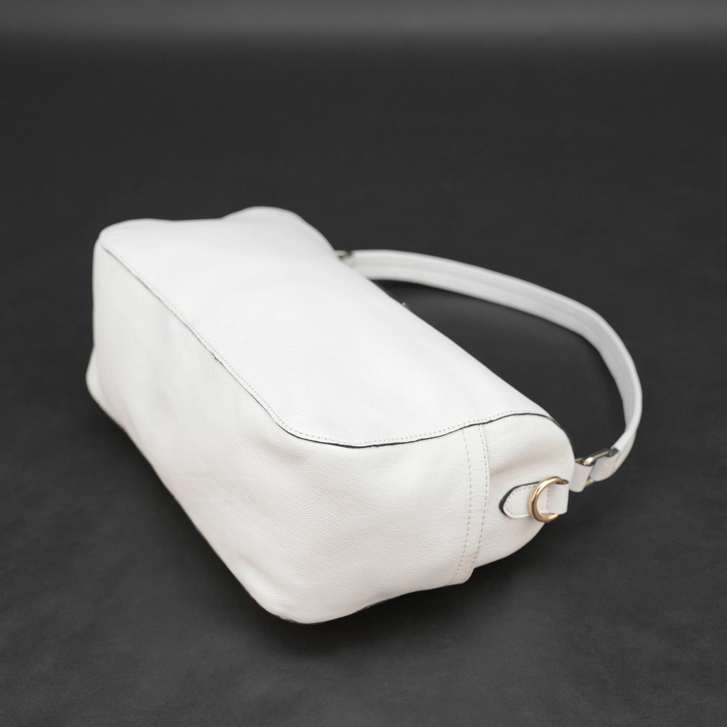 White goat leather bag with zip closure, multiple pockets, and durable everyday design.