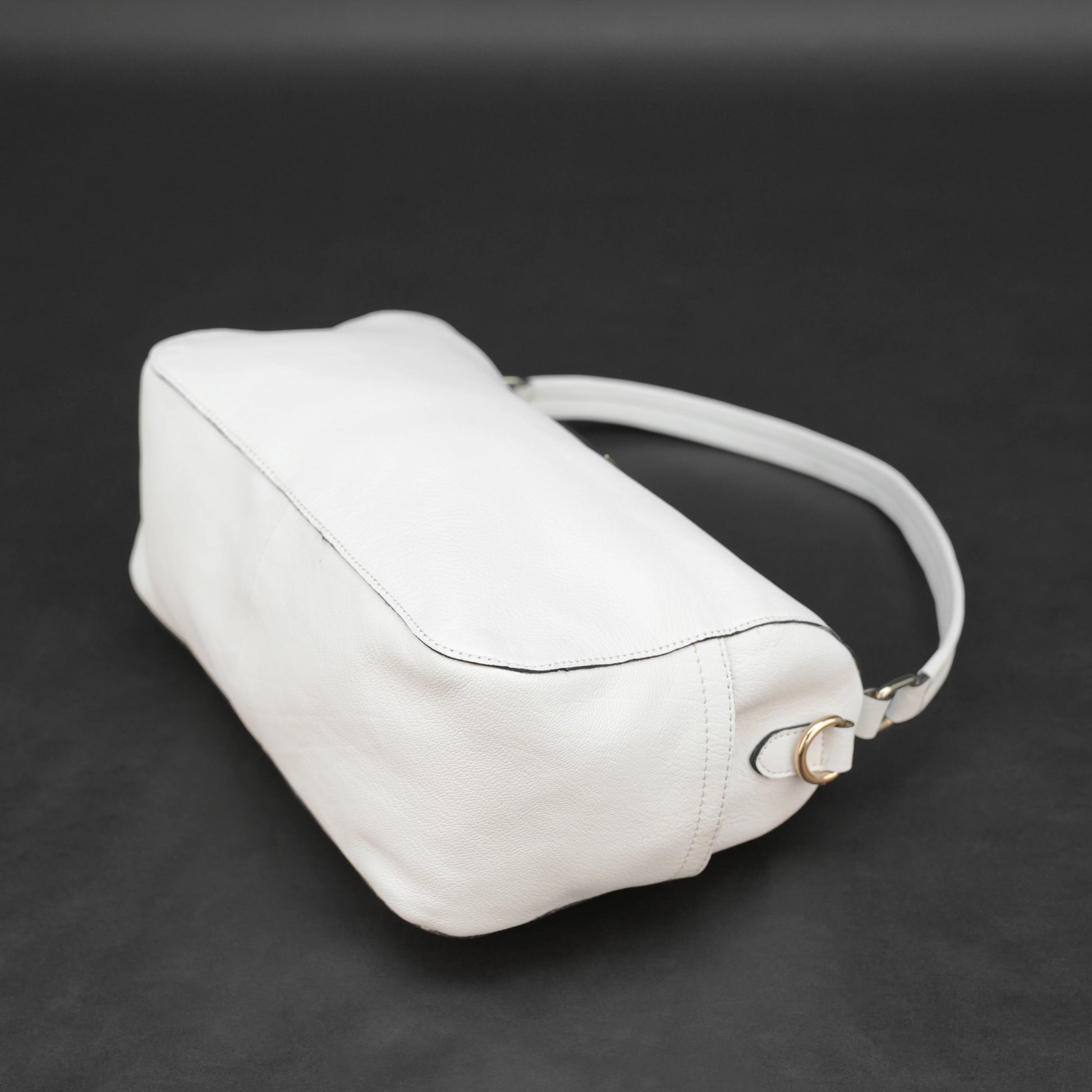 White goat leather bag with zip closure, multiple pockets, and durable everyday design.