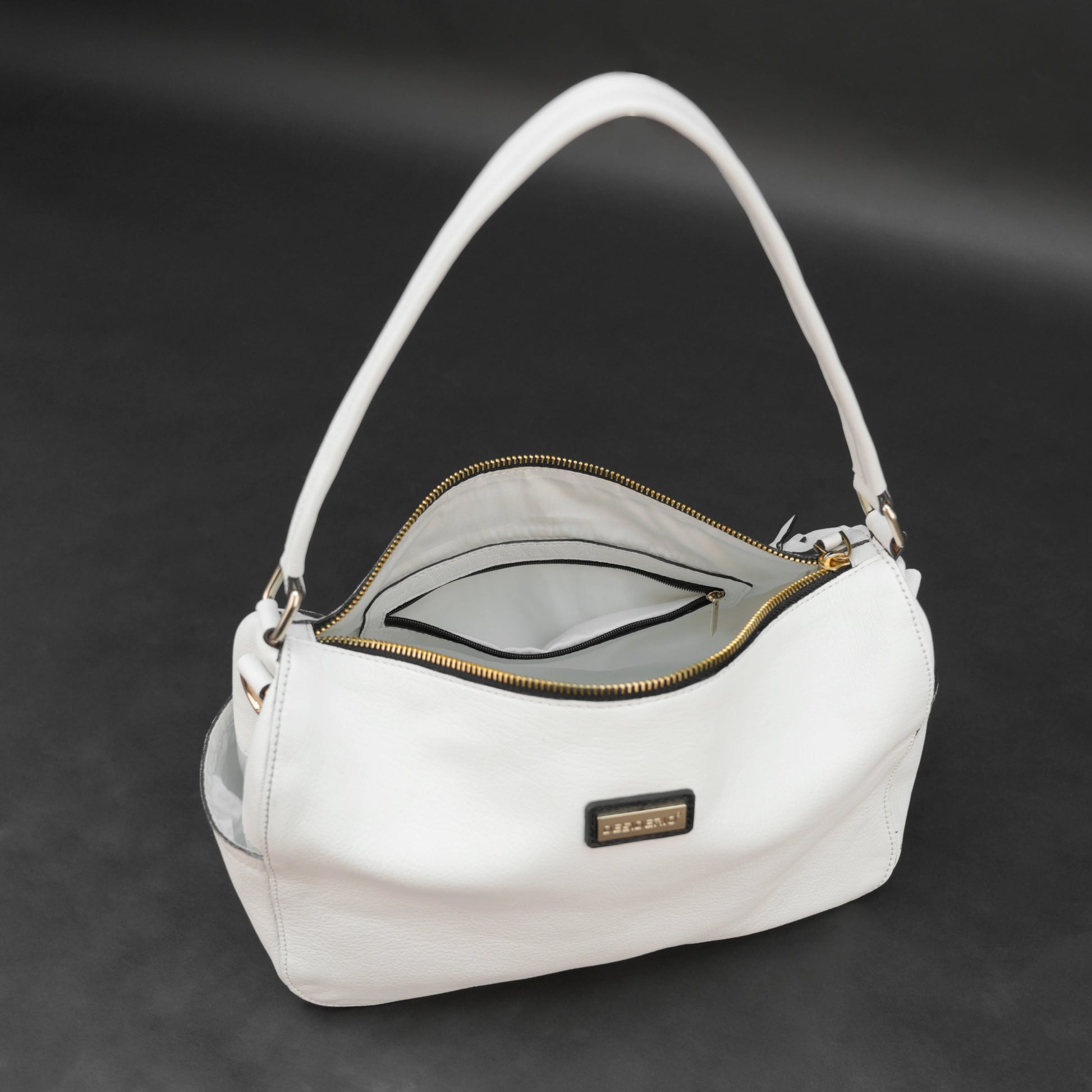 White goat leather bag with zip closure, multiple pockets, and durable everyday design.