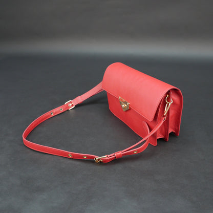 Red sheep leather bag with chain strap, two compartments, and zipper pocket.