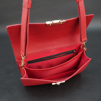 Red sheep leather bag with chain strap, two compartments, and zipper pocket.