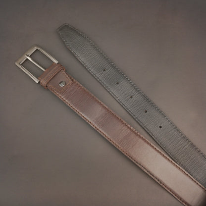Premium leather belt with solid one-piece construction, charcoal metal buckle, durable, adjustable, stylish for jeans and dress wear