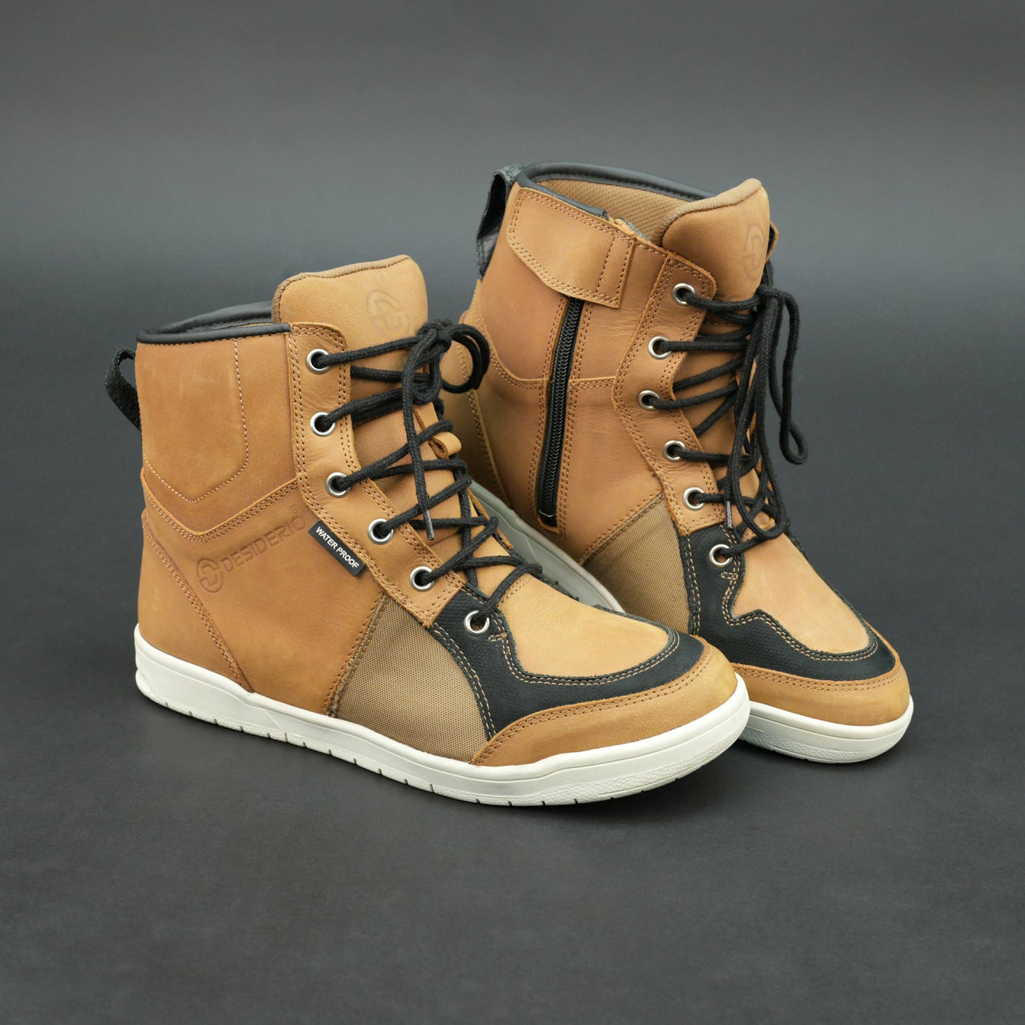 Tan and black motorbike boots with mesh panels and white sole.