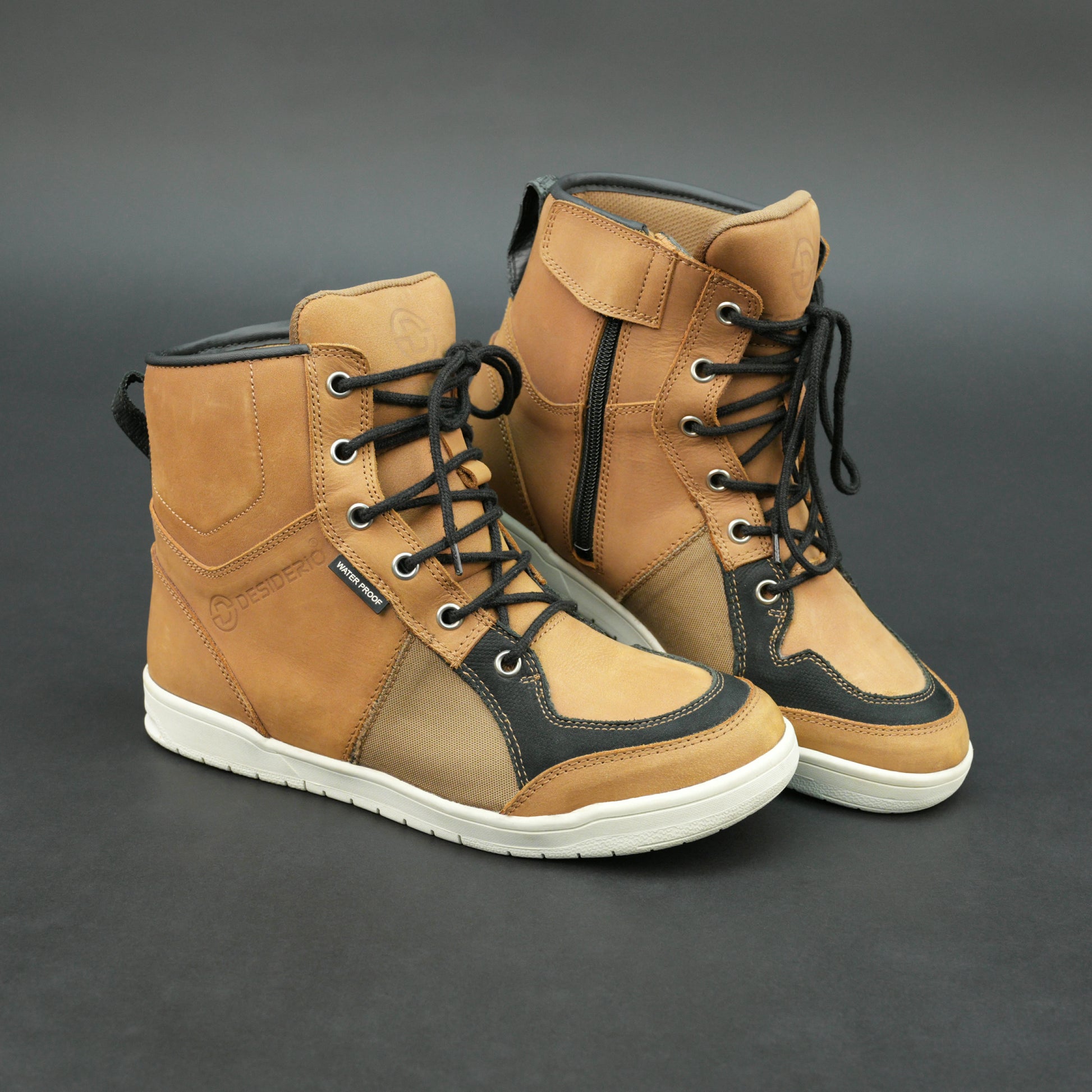 Tan and black motorbike boots with mesh panels and white sole.