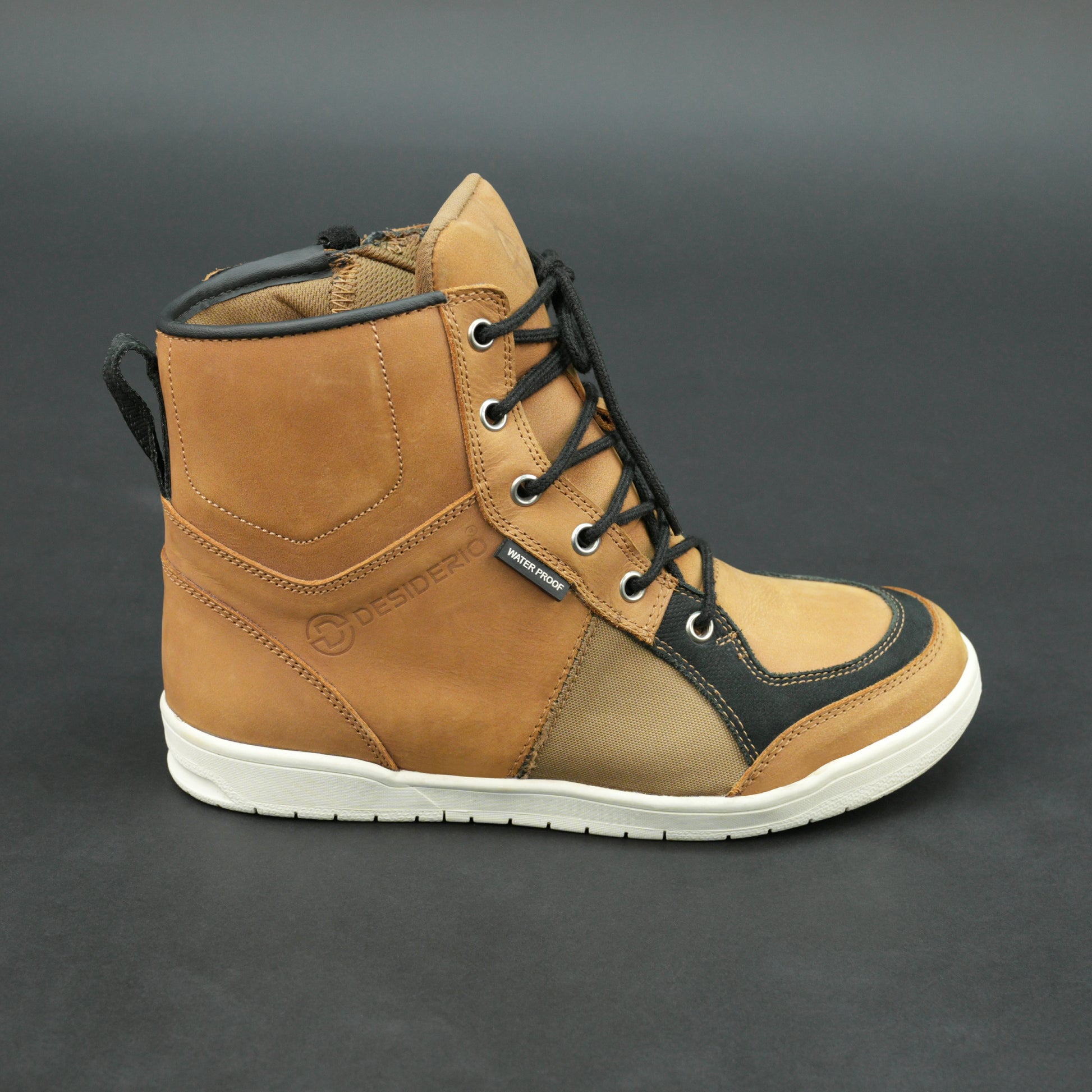 Tan and black motorbike boots with mesh panels and white sole.