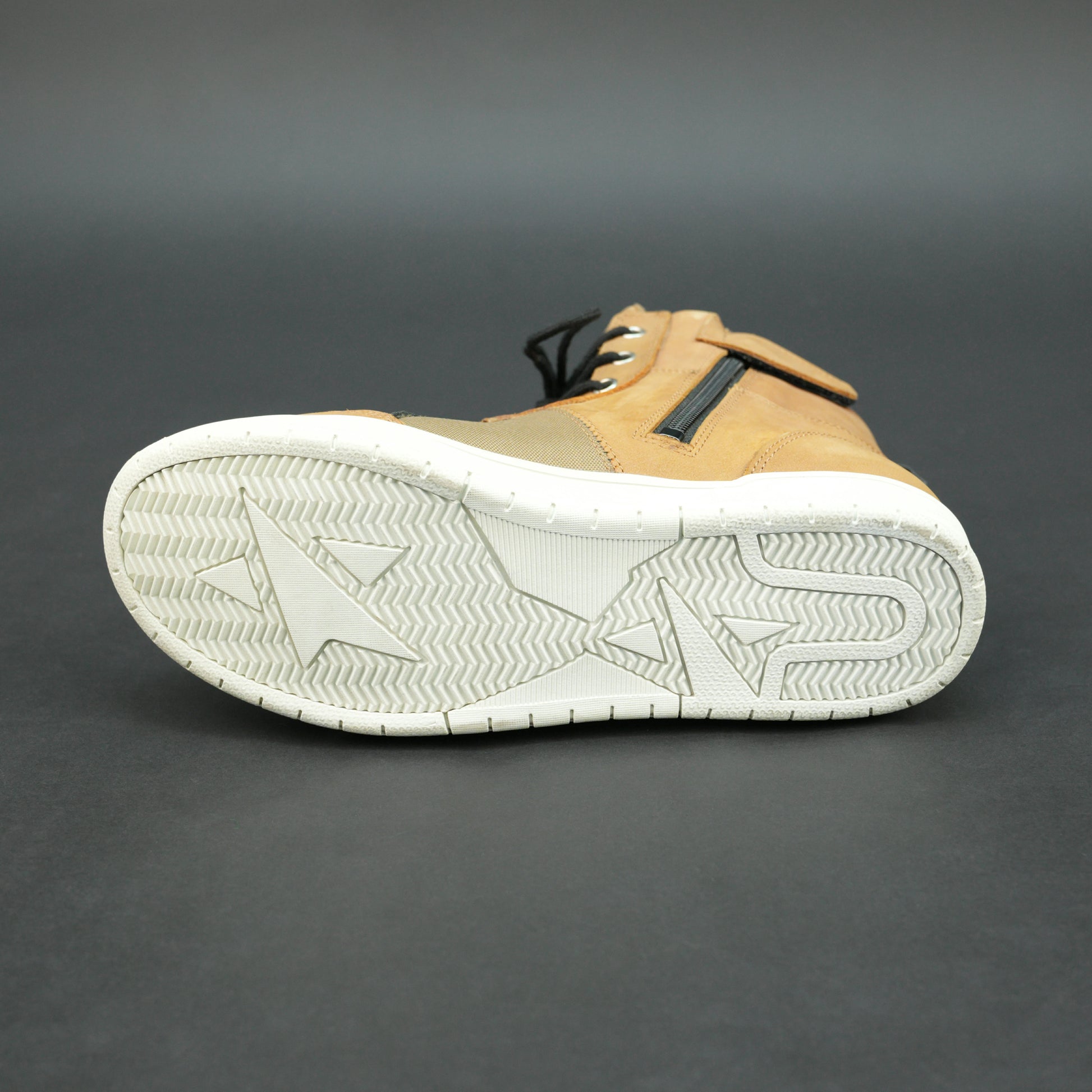 Tan and black motorbike boots with mesh panels and white sole.